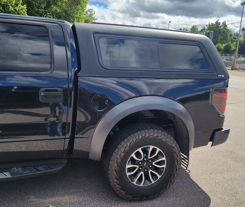 Vehicle image showcasing rugged off-road tires and sleek design.