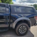 Vehicle image showcasing rugged off-road tires and sleek design.