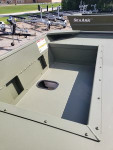 Aluminum boat with spacious interior and storage compartment, perfect for fishing and water activities.