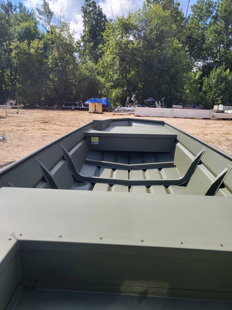Aluminum fishing boat with seating for outdoor water sports and fishing adventures.