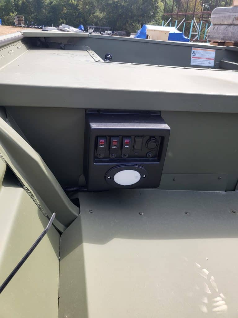Close-up of boat electrical switches and control panel at Camp & Cruise.