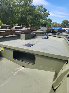 Close-up of military-style boats at Camp & Cruise, showcasing durable construction and outdoor storage.