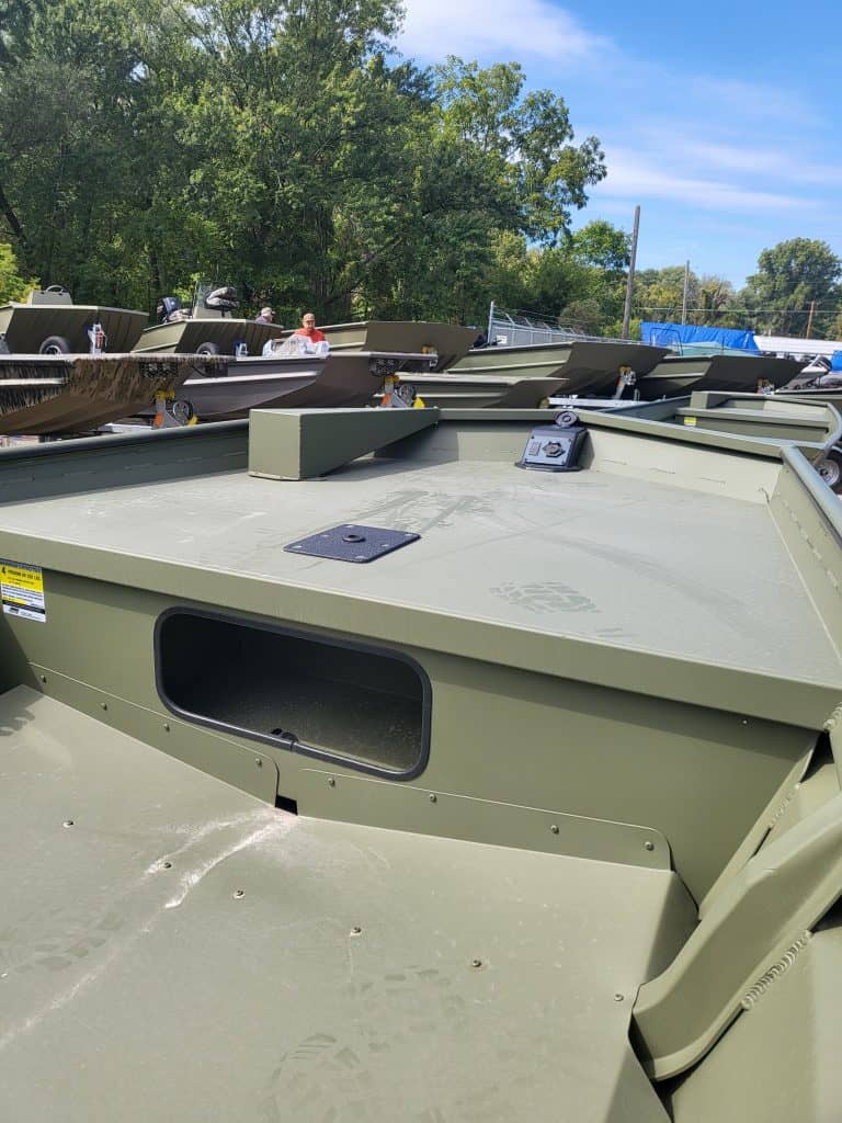 Close-up of military-style boats at Camp & Cruise, showcasing durable construction and outdoor storage.