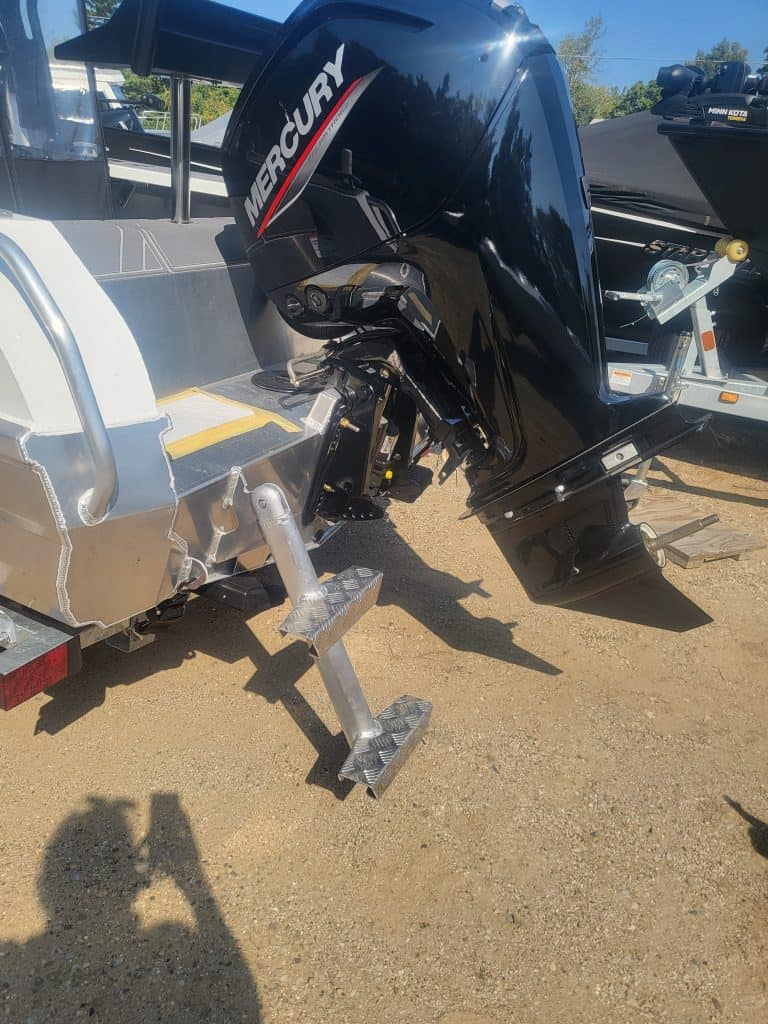 Image of a sleek speedboat equipped with a Mercury outboard motor on a trailer.
