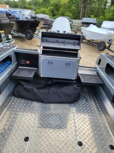Versatile boat with grilling station, storage, and accessories for fishing and water sports.