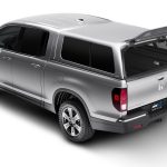 Silver Honda Ridgeline pickup truck with open bed and roof rack for outdoor gear.