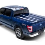 Blue Ford F-150 pickup truck with bed cover, 4x4 drive, and stylish features, perfect for versatile driving.