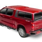 Modern red Chevrolet Silverado with truck bed cover, perfect for outdoor and off-road adventures.