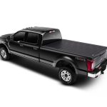 Black electric pickup truck with 4x4 capability and covered bed, modern design, and premium features.
