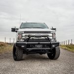 Heavy-duty off-road truck with lift kit and custom bumper at Camp & Cruise.