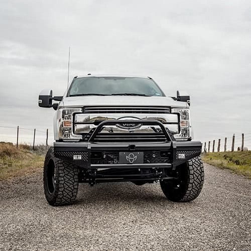 Heavy-duty off-road truck with lift kit and custom bumper at Camp & Cruise.