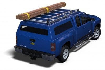 Heavy-duty blue pickup truck with roof racks and lumber on top, ideal for sports equipment transport.