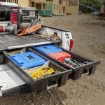Construction tools and equipment organized in the truck bed at Camp & Cruise site.
