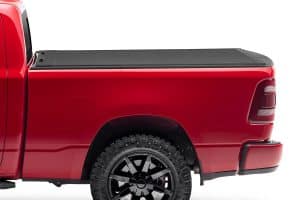 High-quality red pickup truck with rugged off-road tires at Camp & Cruise.