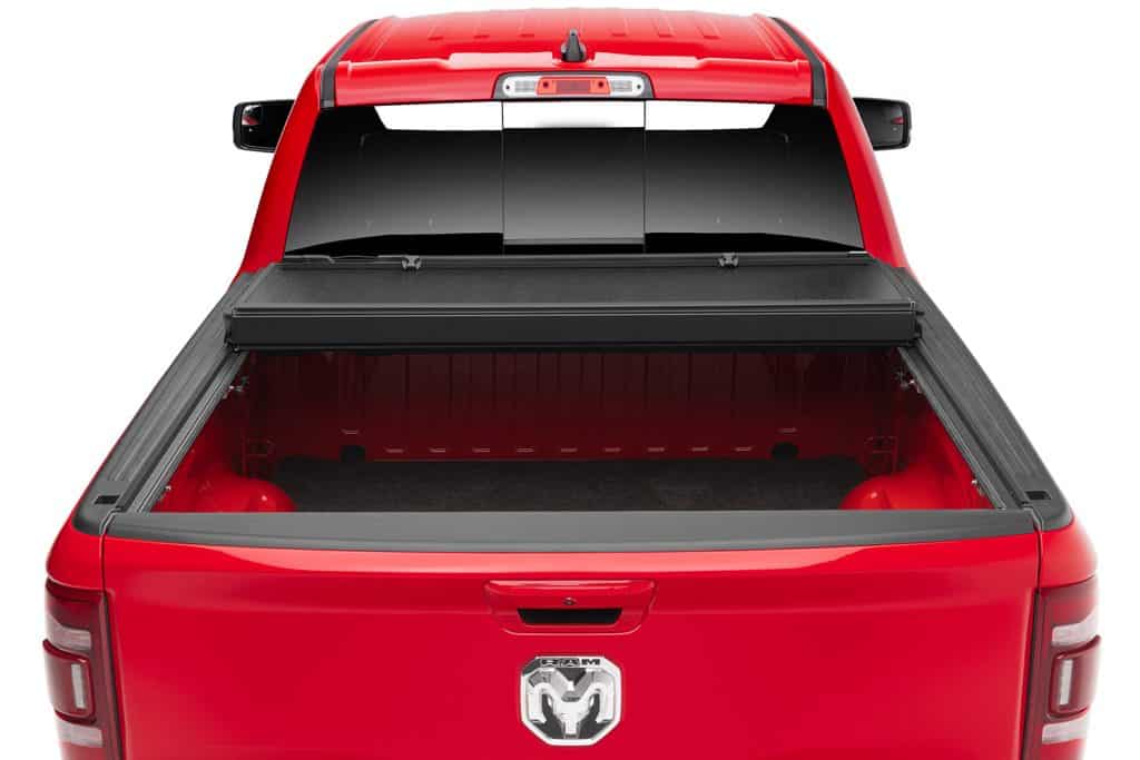 High-resolution image of a red RAM truck with an open bed, emphasizing vehicle accessories and automotive products at Camp & Cruise.