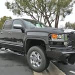 Durable black pickup truck parked outdoors, showcasing rugged design and safety features.