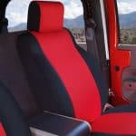 Interior shot of a sporty vehicle at Camp & Cruise, showcasing racing-style red and black seats.