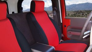 Interior shot of a sporty vehicle at Camp & Cruise, showcasing racing-style red and black seats.