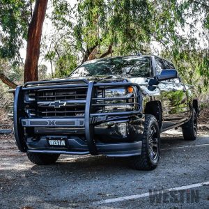 Chevrolet Silverado pickup truck with protective grille guard in outdoor setting.
