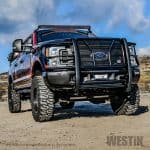 High-performance off-road vehicle with heavy-duty tires and custom front bumper at Camp & Cruise.