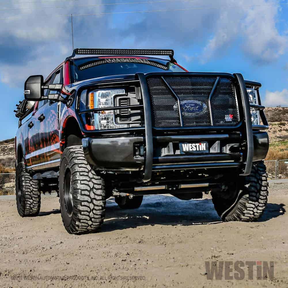 High-performance off-road vehicle with heavy-duty tires and custom front bumper at Camp & Cruise.