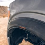 Close-up of an off-road vehicle's LED side light in a desert setting.