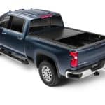 Blue pickup truck with bed cover at Camp & Cruise.