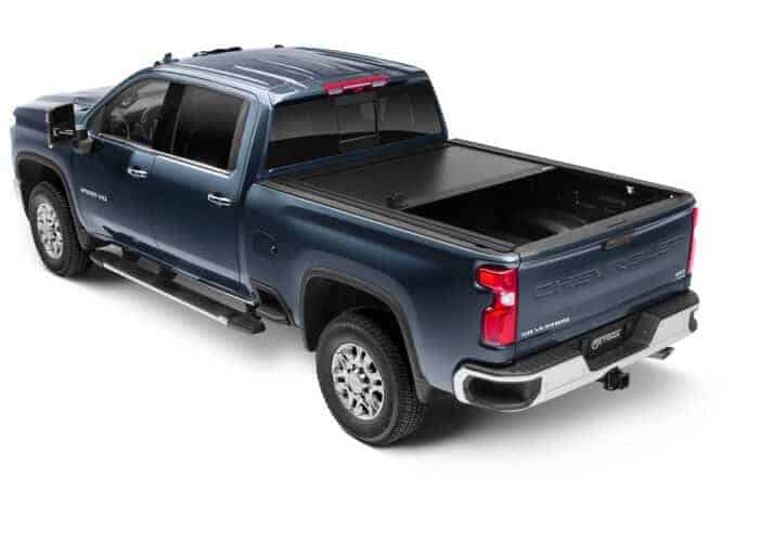 Blue pickup truck with bed cover at Camp & Cruise.