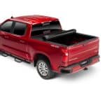 Red pickup truck with truck bed cover showcased at Camp & Cruise, perfect for outdoor sports and adventure gear.
