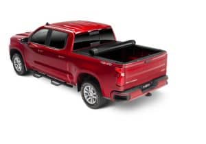 Red pickup truck with truck bed cover showcased at Camp & Cruise, perfect for outdoor sports and adventure gear.