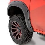 Off-road trucks with rugged tires and wheel fenders at Camp & Cruise.