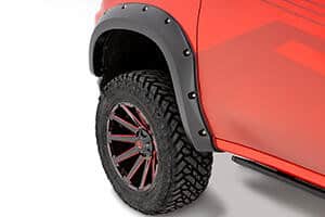 Off-road trucks with rugged tires and wheel fenders at Camp & Cruise.