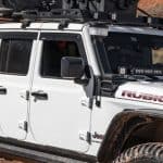 Durable Jeep Rubicon with off-road tires and roof rack at Camp & Cruise.