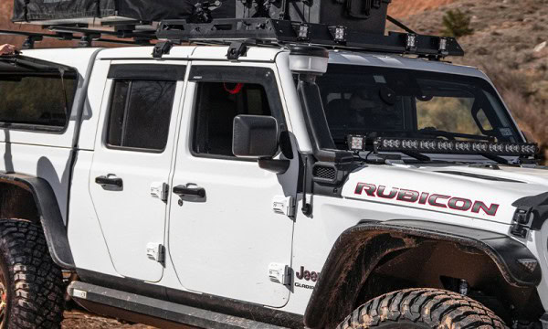 Durable Jeep Rubicon with off-road tires and roof rack at Camp & Cruise.
