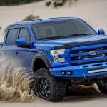 Ford off-road pickup truck in desert terrain for sale at Camp & Cruise.