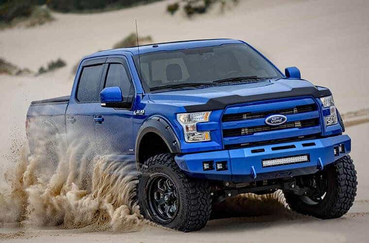 Ford off-road pickup truck in desert terrain for sale at Camp & Cruise.