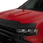 Close-up of a red Chevrolet truck with black grille and LED headlights.