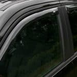 Close-up of a black vehicle window and door frame at Camp & Cruise.