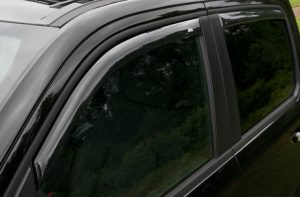 Close-up of a black vehicle window and door frame at Camp & Cruise.