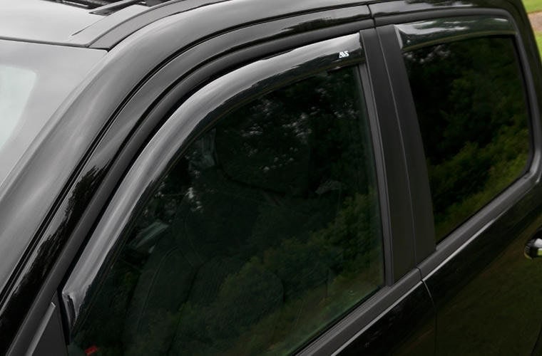 Close-up of a black vehicle window and door frame at Camp & Cruise.