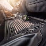 Rubber mud flap protector with "Husky Liners" branding for vehicle floor protection.