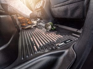 Rubber mud flap protector with "Husky Liners" branding for vehicle floor protection.