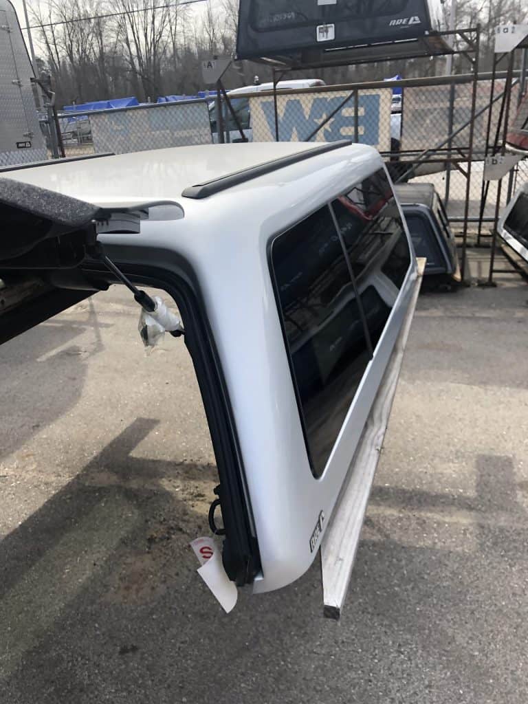 Steel garage door panel with black tinted windows, suitable for residential or commercial use.