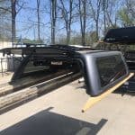 Lightweight truck camper shell with tinted windows at Camp & Cruise, ideal for outdoor adventures.