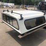 Laser-welded aluminum truck bed cap with roof rack for added cargo space and outdoor sports gear.