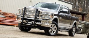 Heavy-duty pickup truck at Camp & Cruise with chrome front grille and off-road tires.