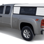 High-quality truck with camper shell available at Camp & Cruise for outdoor adventures.