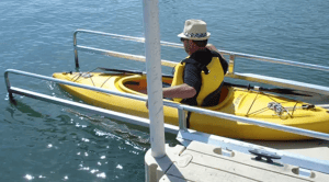 Bright yellow kayak with paddle, perfect for water sports enthusiasts.