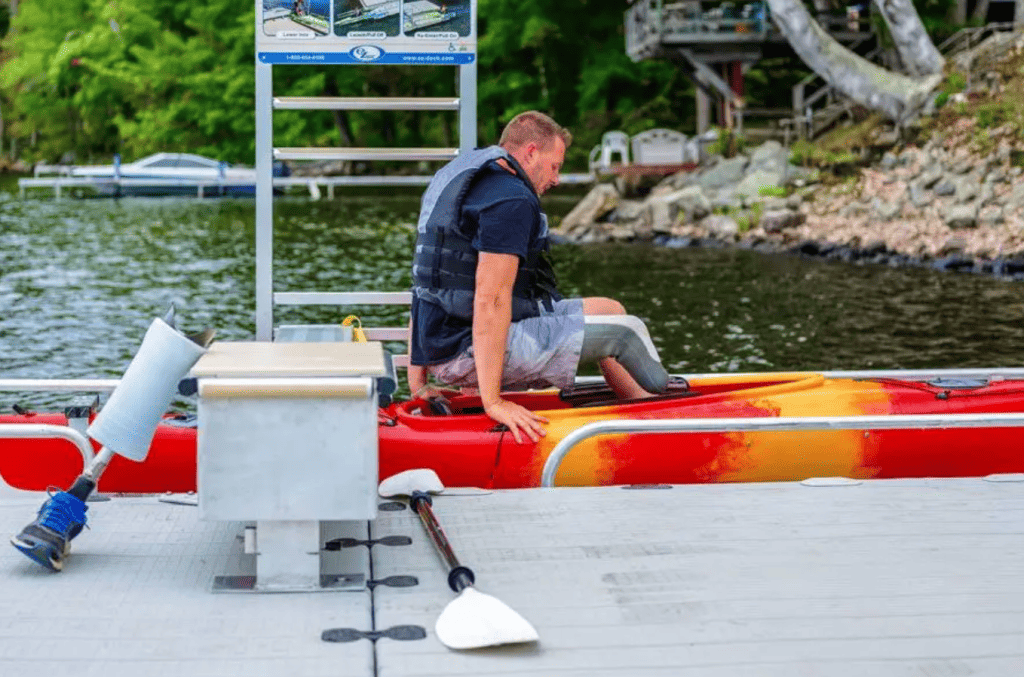 Man preparing kayak for lake, outdoor fishing and water sports activity.