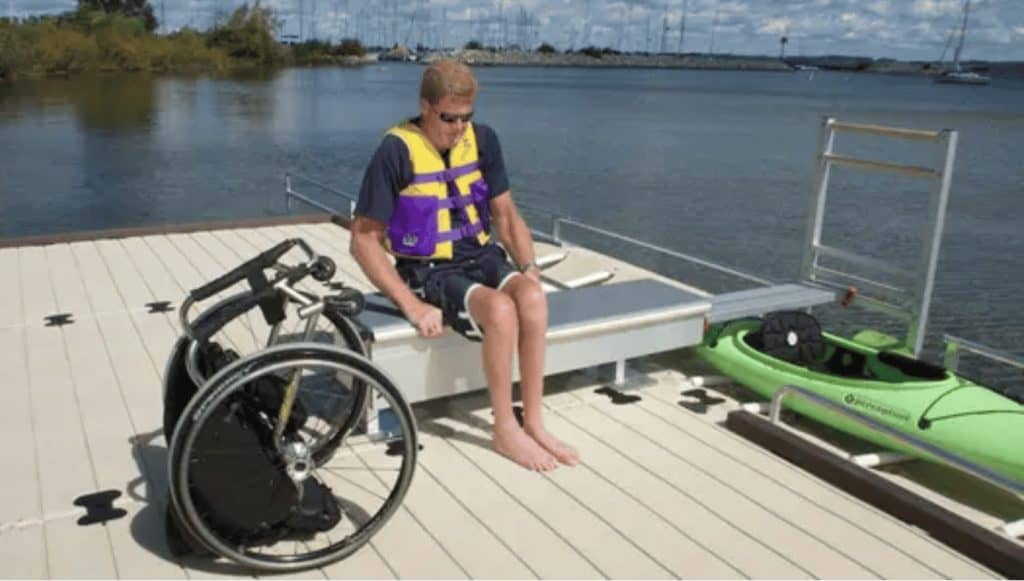 Wheelchair accessible boat dock with adaptive seating and watercraft at Camp & Cruise.
